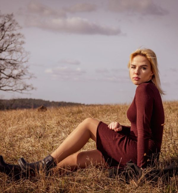 a woman sitting in a field